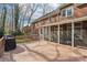 Exterior view of a well-maintained brick home with a spacious back deck and screened porch at 1916 Dugan Dr, Charlotte, NC 28270