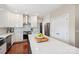 Bright kitchen with white cabinetry, stainless steel appliances, and hardwood floors provides a great layout at 1916 Dugan Dr, Charlotte, NC 28270