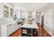 Bright kitchen featuring white cabinets, stainless appliances, hardwood floors, and a large island with a quartz countertop at 1916 Dugan Dr, Charlotte, NC 28270