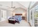 This main bedroom features an ensuite bathroom, a ceiling fan, and an elegant window at 1916 Dugan Dr, Charlotte, NC 28270