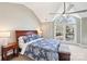 The main bedroom features neutral walls, a large window, and a wooden bed frame at 1916 Dugan Dr, Charlotte, NC 28270