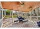 Relaxing screened porch features wood ceiling, ceiling fans, and comfortable patio furniture at 1916 Dugan Dr, Charlotte, NC 28270