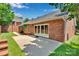 Relaxing backyard featuring a brick home with sliding glass doors and a concrete patio for easy outdoor enjoyment at 1963 Wexford Ct, Gastonia, NC 28054