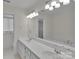 Bathroom with a large vanity, double sinks, and a soaking tub surrounded by tile at 1963 Wexford Ct, Gastonia, NC 28054