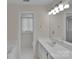 Bright bathroom featuring a white vanity, sink and soaking tub with natural light at 1963 Wexford Ct, Gastonia, NC 28054