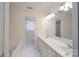 Bathroom with dual sinks, a large mirror, a bathtub, and a shower with natural light at 1963 Wexford Ct, Gastonia, NC 28054