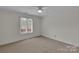 Bedroom with neutral carpet, ceiling fan, and natural light from a large window at 1963 Wexford Ct, Gastonia, NC 28054
