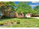 Well-manicured lawn and garden beds add to the curb appeal of this brick home at 1963 Wexford Ct, Gastonia, NC 28054