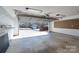 Open garage with concrete floor, shelving, and view of the neighborhood at 1963 Wexford Ct, Gastonia, NC 28054