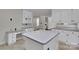 Bright and airy kitchen with white cabinets, tile flooring, and built-in desk area at 1963 Wexford Ct, Gastonia, NC 28054