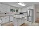 Well-lit kitchen with stainless steel appliances, tile floors, and a center island at 1963 Wexford Ct, Gastonia, NC 28054