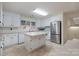 Bright kitchen with stainless steel appliances, an island, tile floors and white cabinets at 1963 Wexford Ct, Gastonia, NC 28054