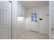 Bright laundry room features tile floors, storage cabinets and exterior door at 1963 Wexford Ct, Gastonia, NC 28054