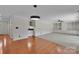 Spacious living room with hardwood floors transitioning to carpet, built-in shelving, and a bar at 1963 Wexford Ct, Gastonia, NC 28054