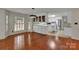 Open-concept living space featuring hardwood floors, white cabinets, and large windows at 1963 Wexford Ct, Gastonia, NC 28054
