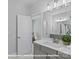 Bathroom with light gray cabinetry and bright white countertop sink at 19728-A School St, Cornelius, NC 28031