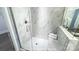 Beautiful glass shower with white marble tile and built-in seat provides a spa-like experience at 19724-B School St, Cornelius, NC 28031