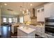 Modern kitchen with stainless steel appliances, tiled backsplash, and island at 19732-B School St, Cornelius, NC 28031