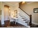 Elegant staircase with wooden railings and a decorative desk in the foyer at 19732-B School St, Cornelius, NC 28031