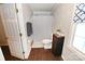 Clean bathroom with a toilet, small vanity, a gray shower curtain and natural light at 2010 Simmons St, Gaston, NC 28052