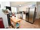 Well-lit kitchen featuring stainless steel appliances, white cabinets, and practical wooden island at 2010 Simmons St, Gaston, NC 28052