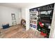 Brightly lit room with visible shelving, ladder, and items strewn on the floor at 2010 Simmons St, Gaston, NC 28052