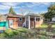 Brick back porch and the exterior of the home features lattice work and white trim at 213 Turner Rd, Gastonia, NC 28056