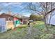 Exterior view of the brick house with a fenced yard and a charcoal grill at 213 Turner Rd, Gastonia, NC 28056