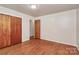 This bedroom features gleaming hardwood floors and a spacious closet at 213 Turner Rd, Gastonia, NC 28056