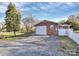 Brick home with a detached garage featuring a large driveway and well-kept lawn at 213 Turner Rd, Gastonia, NC 28056