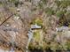 Aerial shot of a single-Gathering home surrounded by dense trees and a long driveway at 230 Valley View Dr, Clover, SC 29710