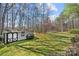 Backyard view featuring a storage shed and a sprawling green lawn surrounded by tall trees at 230 Valley View Dr, Clover, SC 29710