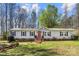 Charming single-story home with a brick foundation, red front door, black shutters, and a well-manicured lawn at 230 Valley View Dr, Clover, SC 29710