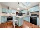 Bright kitchen with skylights, a functional island, stainless steel appliances, and blue cabinets at 230 Valley View Dr, Clover, SC 29710