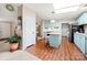 Kitchen with a skylight, blue cabinets, modern appliances, and wood-look vinyl flooring at 230 Valley View Dr, Clover, SC 29710