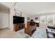 The well-lit living room includes a media center, desk, and multiple windows with natural light at 230 Valley View Dr, Clover, SC 29710