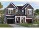 Two-story duplex with vertical siding, a shared front porch, and two single-car garages at 2522 Elkwood Cir, Charlotte, NC 28205