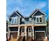 New construction duplex featuring a modern facade, private entrances, and attached garages at 2522 Elkwood Cir, Charlotte, NC 28205