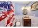 Bathroom featuring a stars and stripes shower curtain and a vanity with a marble-look countertop at 2561 Ellys St, Lincolnton, NC 28092