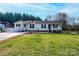 Charming single-story home features a well-maintained lawn, quaint porch, and classic American flag at 2561 Ellys St, Lincolnton, NC 28092