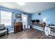 Inviting living room with beautiful blue walls, wood-look floors, and a classic desk at 2561 Ellys St, Lincolnton, NC 28092