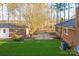 Backyard view of home showing brick, AC unit, patio, and mature trees at 2750 Morgan Rd, Gold Hill, NC 28071