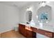 Bathroom featuring wood cabinets, neutral walls, and a decorative mirror at 2750 Morgan Rd, Gold Hill, NC 28071