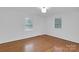 Bright bedroom with hardwood floors and two windows offering natural light at 2750 Morgan Rd, Gold Hill, NC 28071