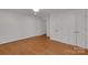 Bright bedroom featuring hardwood floors, white walls, and ample closet space at 2750 Morgan Rd, Gold Hill, NC 28071