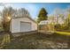 View of the garage and greenhouse on the property with white siding and a paved area in front at 2750 Morgan Rd, Gold Hill, NC 28071