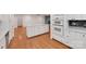 Bright kitchen featuring white cabinetry, modern appliances, and hardwood floors at 2750 Morgan Rd, Gold Hill, NC 28071