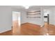 Spacious living room with hardwood floors and open shelving at 2750 Morgan Rd, Gold Hill, NC 28071