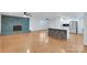 Open living space featuring a stylish kitchen island, fireplace, and hardwood floors at 2750 Morgan Rd, Gold Hill, NC 28071