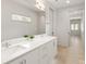 Bathroom featuring double sink vanity, light colored walls, modern mirrors, and natural light at 2924 Springs Dr, Charlotte, NC 28226